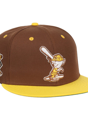 The EFF Cordoba Cafeteros DNA Fitted Ballcap is a vintage-inspired brown cap with a yellow brim, featuring a cartoon baseball character on the front and a yellow-brown side patch, echoing classic Ebbets Field Flannels style.