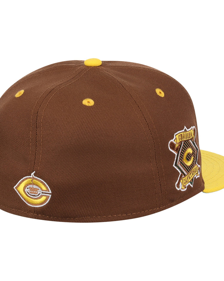 The Cordoba Cafeteros EFF DNA Fitted Ballcap by EFF is a vintage-inspired brown cap with yellow accents, patches on the side and back, a circular logo, yellow top button, and a yellow flat brim.
