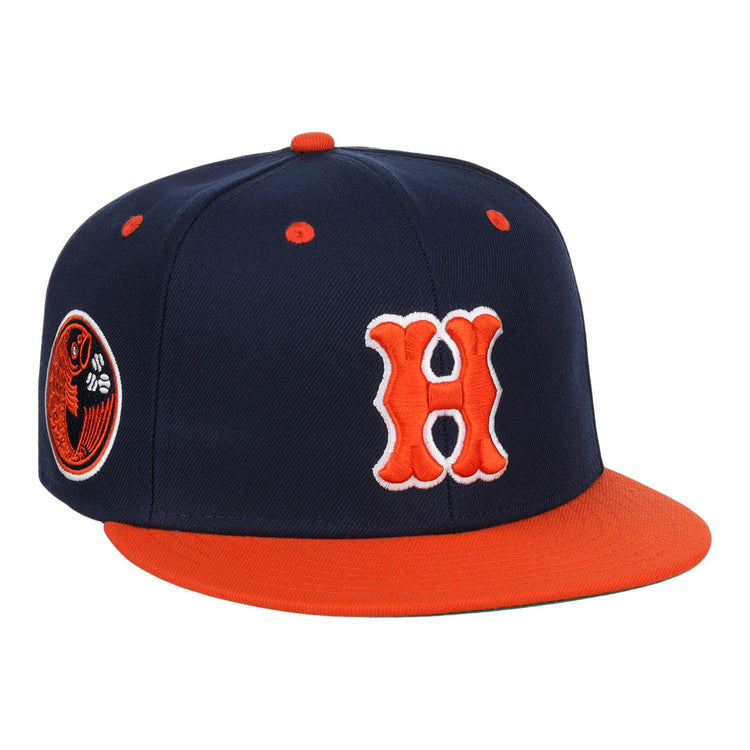 The EFF Hiroshima Carp EFF DNA Fitted Ballcap features navy blue with an orange brim, button, and eyelets, a bold orange and white H on the front in Carp style, and a circular side patch. Inspired by vintage Ebbets Field Flannels.