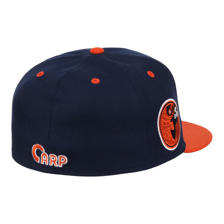 The EFF Hiroshima Carp EFF DNA Fitted Ballcap is navy blue with orange accents, an orange brim and button, a circular fish logo on the side, CARP embroidered on the back, in classic Ebbets Field Flannels style.