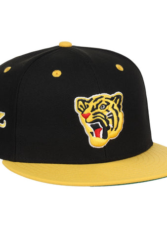 The EFF Osaka Tigers EFF DNA Fitted Ballcap features a black and yellow vintage look with a yellow brim, an embroidered roaring tiger face on the front, and a triangular logo on the side, inspired by classic Japanese baseball style.