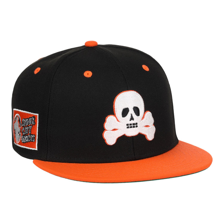 The Sioux City Ghosts EFF DNA Fitted Ballcap by EFF is a vintage-inspired black cap with orange accents, a white skull and crossbones on the front, and a side patch honoring the Sioux City Ghosts.