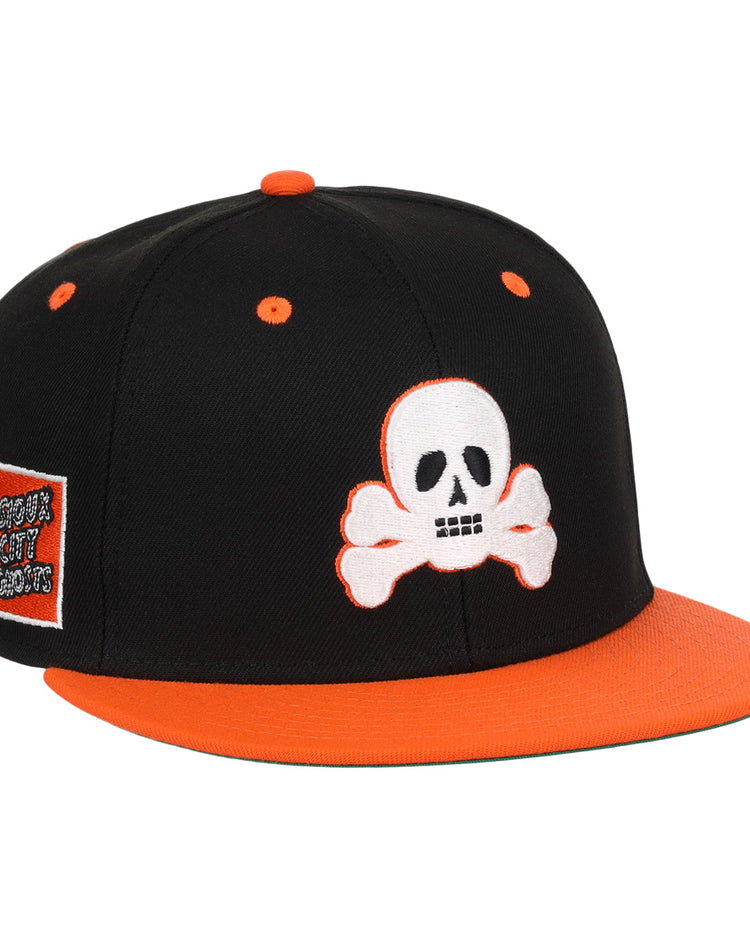 The Sioux City Ghosts EFF DNA Fitted Ballcap by EFF is a vintage-inspired black cap with orange accents, a white skull and crossbones on the front, and a side patch honoring the Sioux City Ghosts.