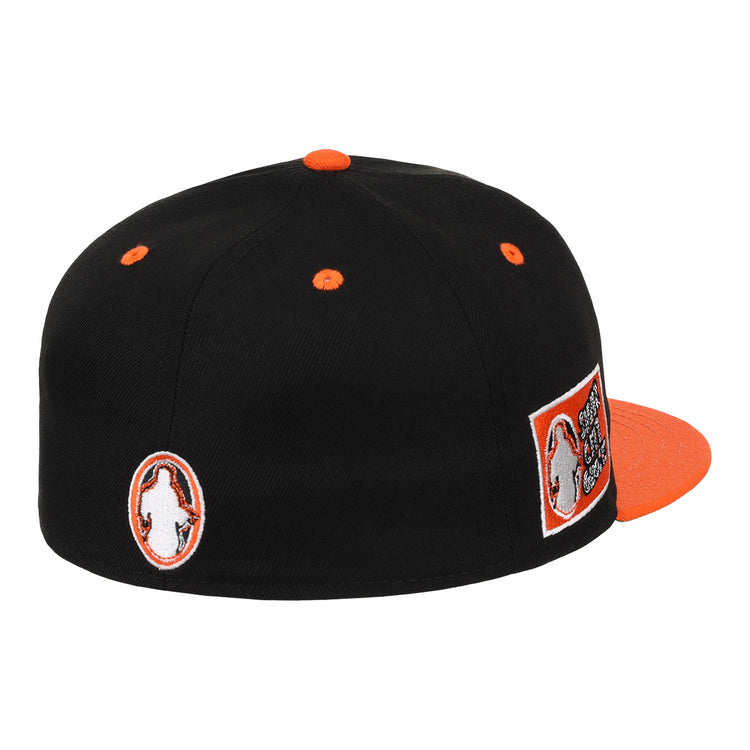 The EFF Sioux City Ghosts DNA Fitted Ballcap is a black vintage-inspired cap with orange accents, multiple patches including the teams logo, orange eyelets, and a flat orange brim, shown from the back and side.