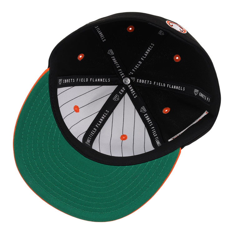 A look inside the Sioux City Ghosts EFF DNA Fitted Ballcap by EFF, featuring a green underbrim, orange accents, white pinstripes, and vintage-inspired style with classic quality details.