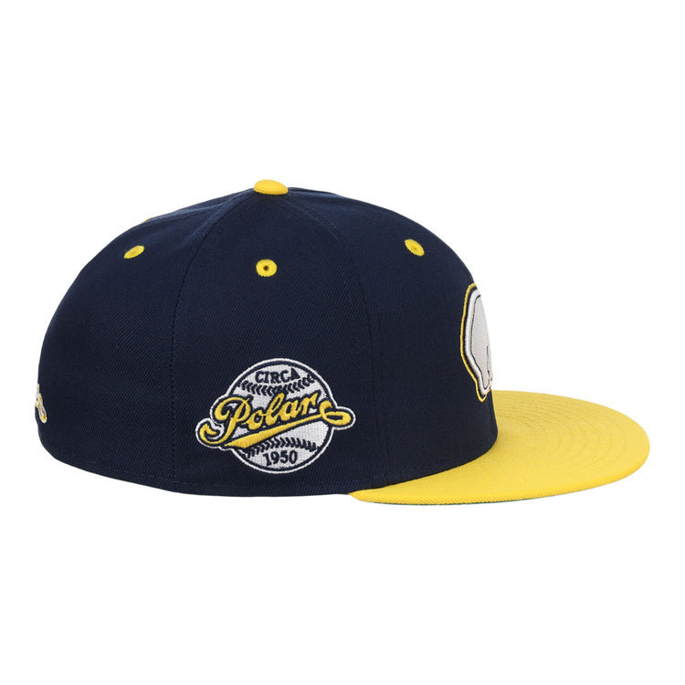 The EFF Cerveceria Polar EFF DNA Fitted Ballcap is a vintage-inspired navy cap with a bright yellow brim and top button, detailed with embroidered patches like the 1950 Polar logo, echoing classic Ebbets Field Flannels style.