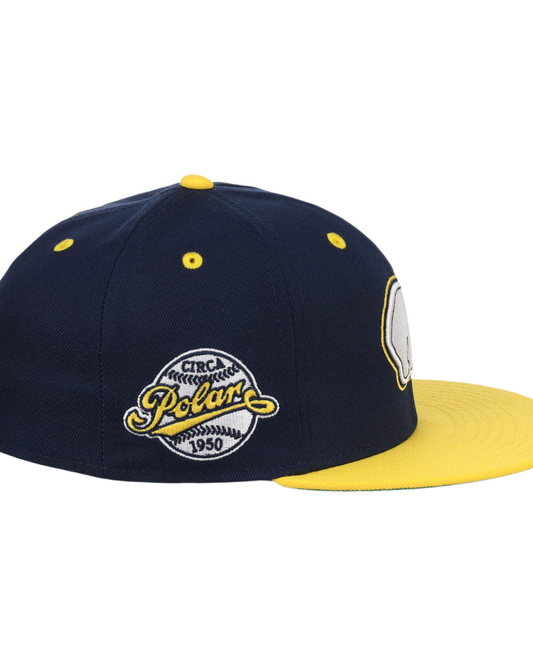 The EFF Cerveceria Polar EFF DNA Fitted Ballcap is a vintage-inspired navy cap with a bright yellow brim and top button, detailed with embroidered patches like the 1950 Polar logo, echoing classic Ebbets Field Flannels style.