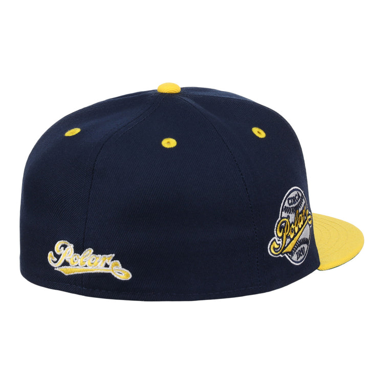 The EFF Cerveceria Polar DNA Fitted Ballcap is a navy vintage-inspired cap with yellow accents, a yellow brim and button, Pelore script embroidery on the side, and a circular Pelore patch on the back. Inspired by Ebbets Field Flannels.