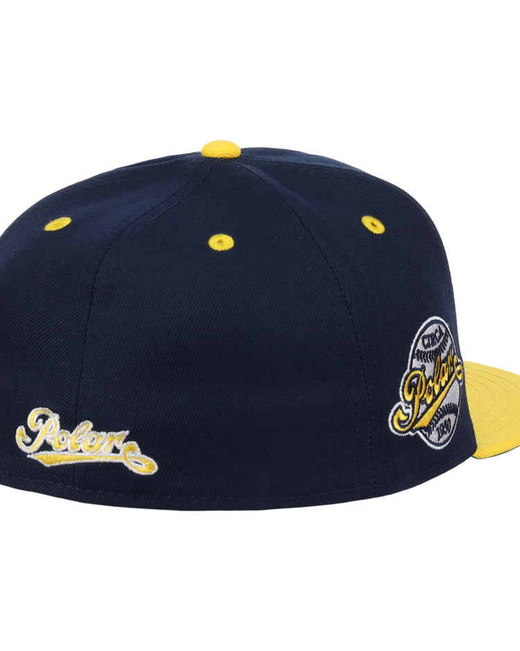 The EFF Cerveceria Polar DNA Fitted Ballcap is a navy vintage-inspired cap with yellow accents, a yellow brim and button, Pelore script embroidery on the side, and a circular Pelore patch on the back. Inspired by Ebbets Field Flannels.