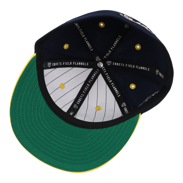 The Cerveceria Polar EFF DNA Fitted Ballcap by EFF features a green bill, yellow stitching, white pinstripe lining, black “Ebbets Field Flannels” bands inside, and yellow eyelets—honoring the Cuban Amateur League’s rich history.