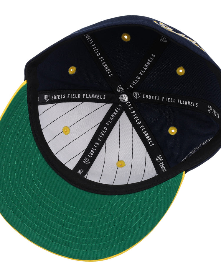The Cerveceria Polar EFF DNA Fitted Ballcap by EFF features a green bill, yellow stitching, white pinstripe lining, black “Ebbets Field Flannels” bands inside, and yellow eyelets—honoring the Cuban Amateur League’s rich history.