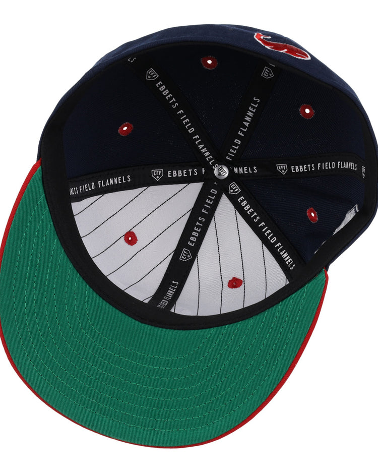 The Chicago Whales EFF DNA Fitted Ballcap from EFF features a vintage look with navy and white panels inside, a green brim with red trim, and black bands printed with “EBBETS FIELD FLANNELS” for classic style.