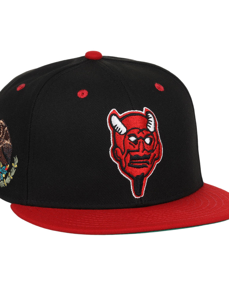 The EFF Mexico Diablos EFF DNA Fitted Ballcap is a black and red hat featuring a red horned devil patch, an embroidered Mexican eagle on the side, and vintage-inspired details in classic Mexican League style.
