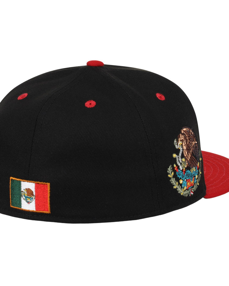 The Mexico Diablos EFF DNA Fitted Ballcap by EFF features a black crown, red brim, the Mexican national emblem embroidered on the front, and the Mexican flag on the side—a vintage-inspired tribute to Mexican League style.