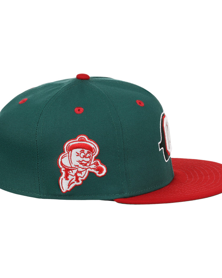 The Oakland Oaks EFF DNA Fitted Ballcap by EFF is a vintage-inspired green fitted cap with a red brim, cartoon ghost patch on the side, ventilation holes on top, and classic Ebbets Field Flannels style.