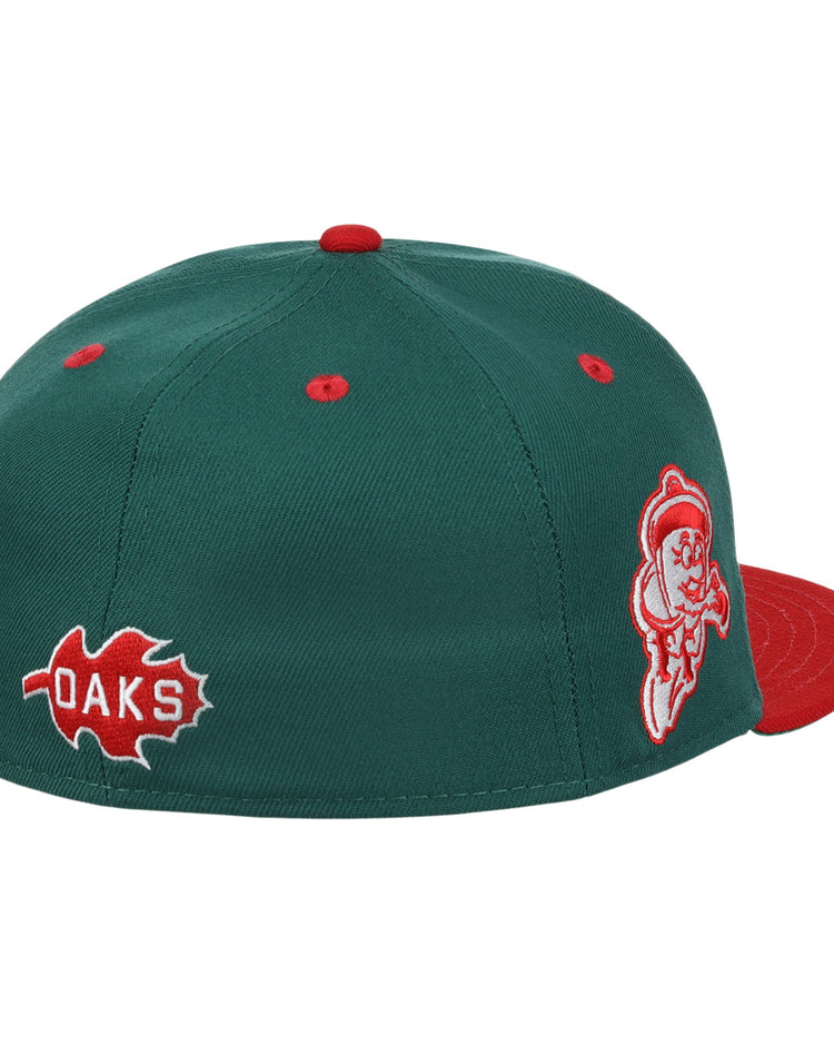 The Oakland Oaks EFF DNA Fitted Ballcap by EFF is a green vintage-inspired cap with a red brim, top button, and eyelets, plus side red oak leaf and OAKS patches with a white-outlined mascot—classic Ebbets Field Flannels style.