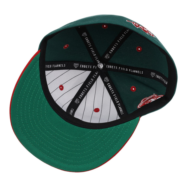 The Oakland Oaks EFF DNA Fitted Ballcap by EFF is shown upside down, highlighting its inner lining with Ebbets Field Flannels branding and red stitched details on the inside panels.