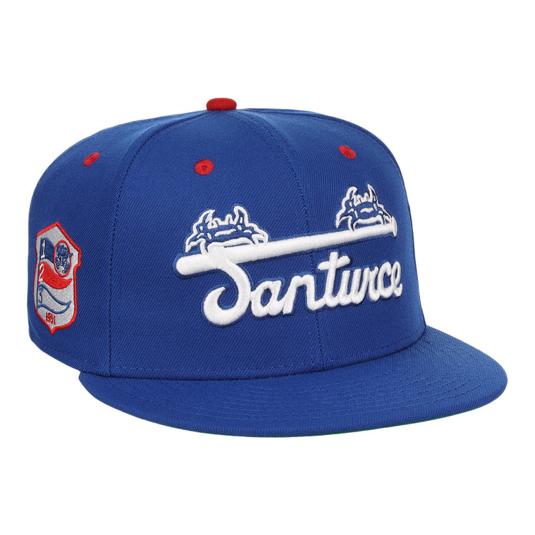 The EFF Santurce Cangrejeros NLB Team Color Fitted Ballcap is a vintage-inspired blue hat with Santurce in white under two blue and white crab logos, plus a Puerto Rican League red and white side patch and red accents on the top and eyelets.