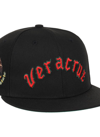 The EFF Veracruz Azules NLB Team Color Fitted Ballcap is a black hat with red gothic lettering on the front and the Mexican emblem on the side—ideal for fans wanting a vintage-inspired Mexican League style.