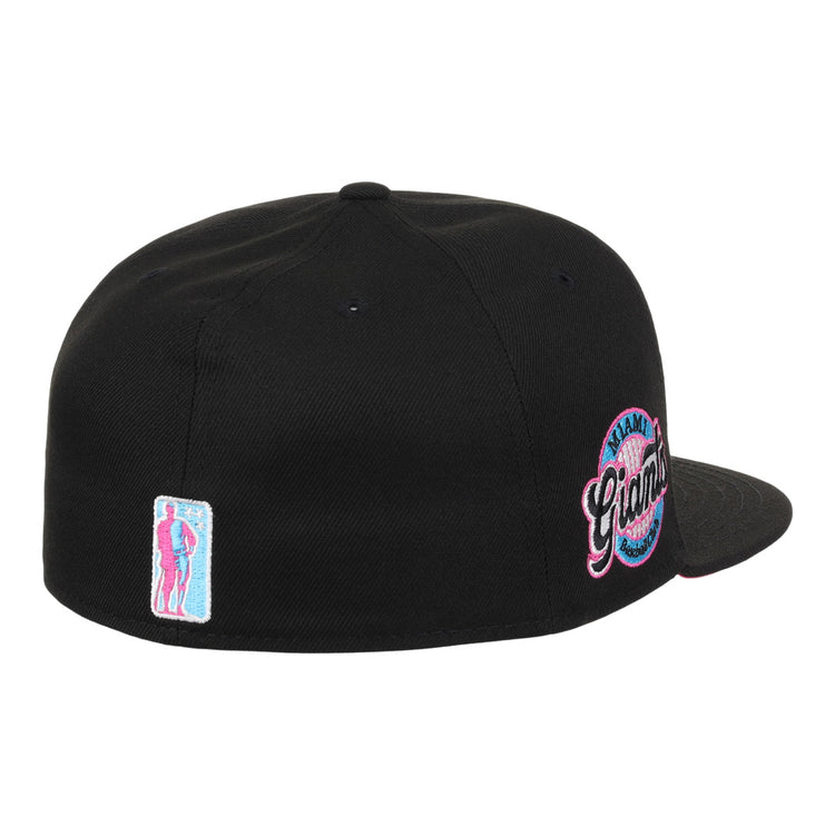 The EFF Miami Giants NLB Team Color Fitted Ballcap in black features a back view, an embroidered team logo patch, and a small pink and blue figure patch on the left, honoring this historic Black barnstorming team.