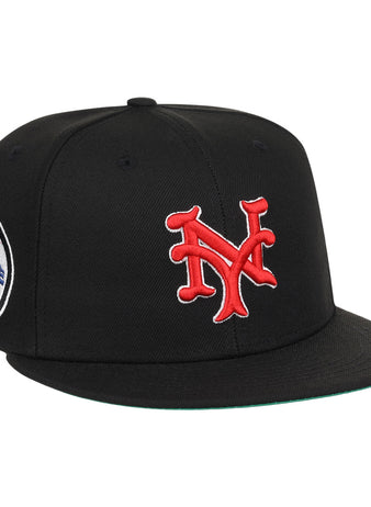 The EFF New York Cubans NLB Team Color Fitted Ballcap is a vintage-inspired black cap with a 3D red NY logo on the front and a round New York Giants patch on the side.