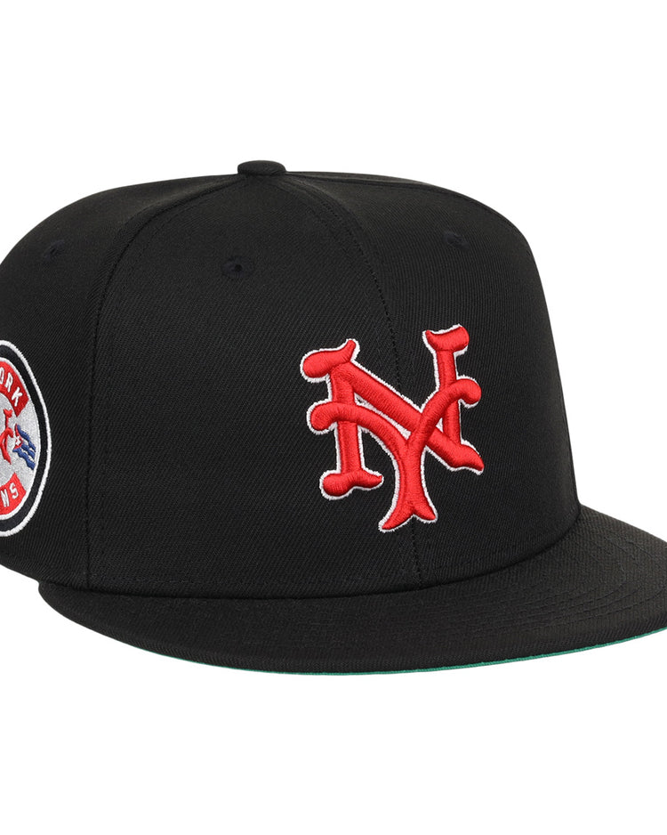 The EFF New York Cubans NLB Team Color Fitted Ballcap is a vintage-inspired black cap with a 3D red NY logo on the front and a round New York Giants patch on the side.
