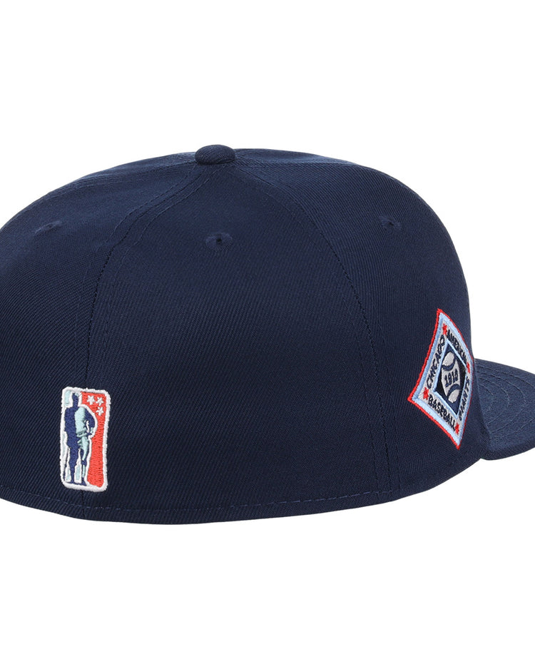 The EFF Chicago American Giants NLB Team Color Fitted Ballcap is a navy blue crown cap with a flat brim, featuring a silhouette logo patch on the back and a diamond-shaped text logo patch on the side, inspired by vintage NLB Flip styles.