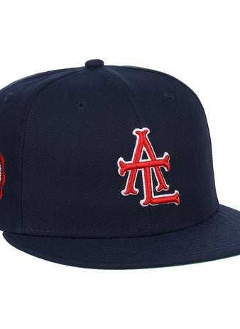 The EFF Atlanta Black Crackers NLB Team Color Fitted Ballcap is a vintage-inspired navy hat featuring a bold red and white logo on the front and an orange-and-black round patch on the side.