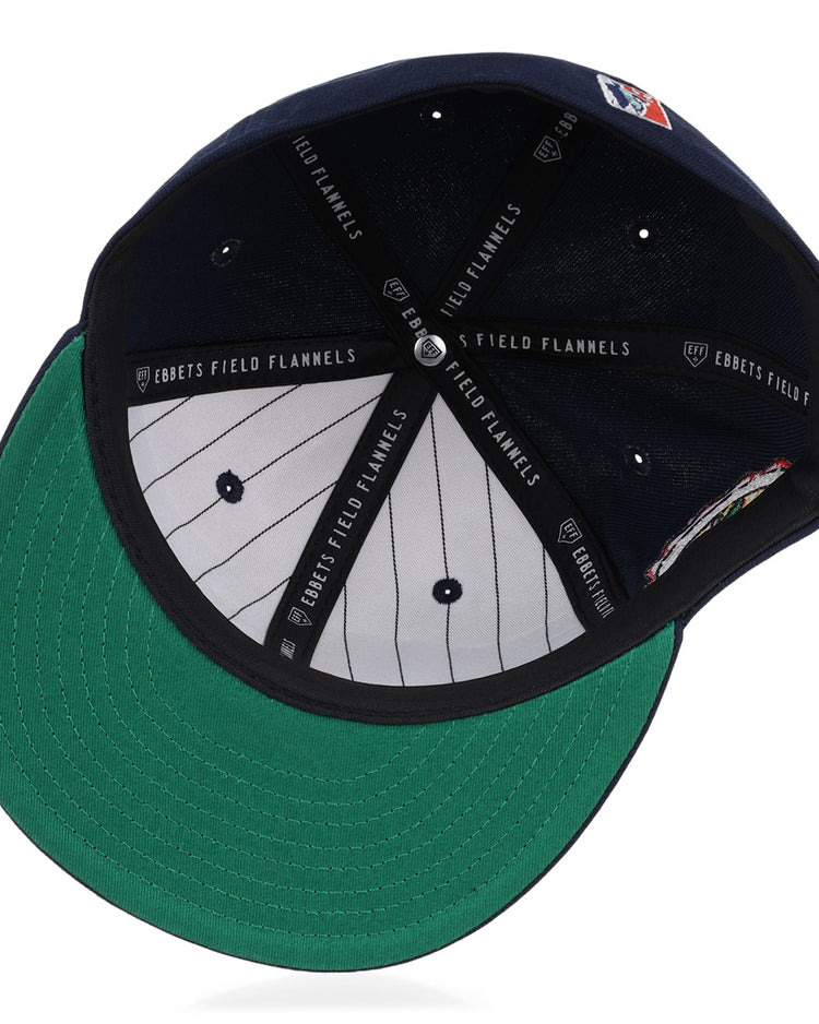 An inside view of the Atlanta Black Crackers NLB Team Color Fitted Ballcap by EFF, featuring a green underbill, black EFF-marked sweatband, grey pinstriped lining, and visible top button with vent holes.
