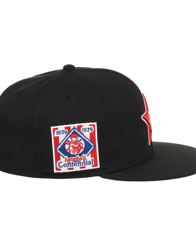The EFF Philadelphia Stars NLB Team Color Fitted Ballcap is a black flat-brim cap with an embroidered Star logo, plus a side patch reading 1839 1939 Baseball Centennial with a red baseball figure, honoring the Negro National League.