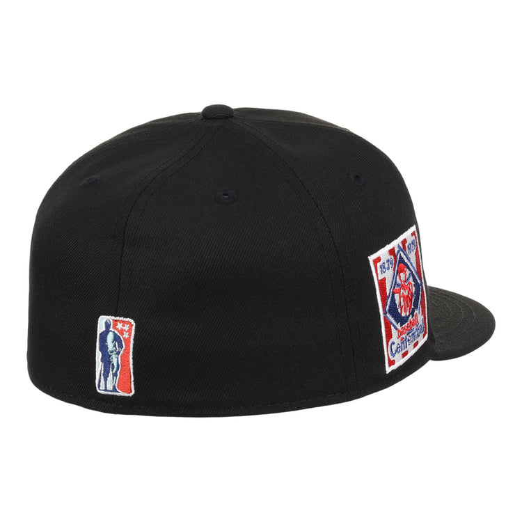 The EFF Philadelphia Stars NLB Team Color Fitted Ballcap is a black cap featuring a rectangular fire department emblem patch with red, white, and blue details on the side and an embroidered Star logo patch on the back.