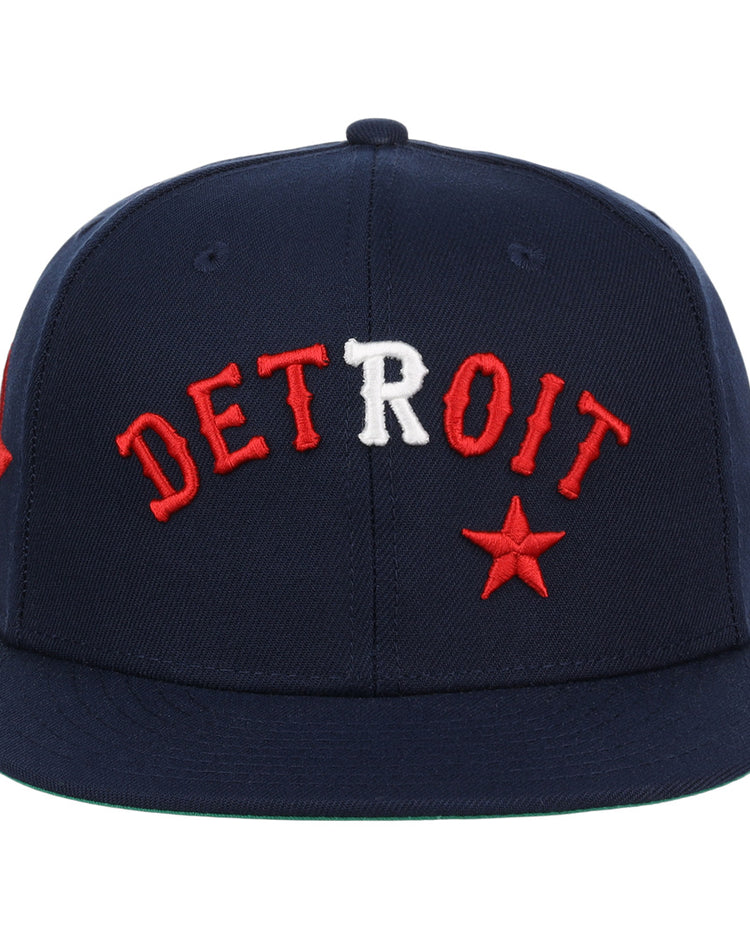 The EFF Detroit Stars NLB Team Color Fitted Ballcap is a vintage-inspired navy cap with bold red and white DETROIT embroidery and a red star, celebrating the legacy of the Negro National League.