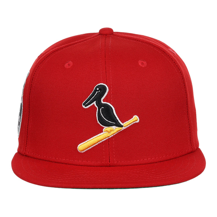 The EFF New Orleans Black Pelicans NLB Team Color Fitted Ballcap in red features an embroidered black pelican on a yellow bat, honoring the historic Negro Southern League team.