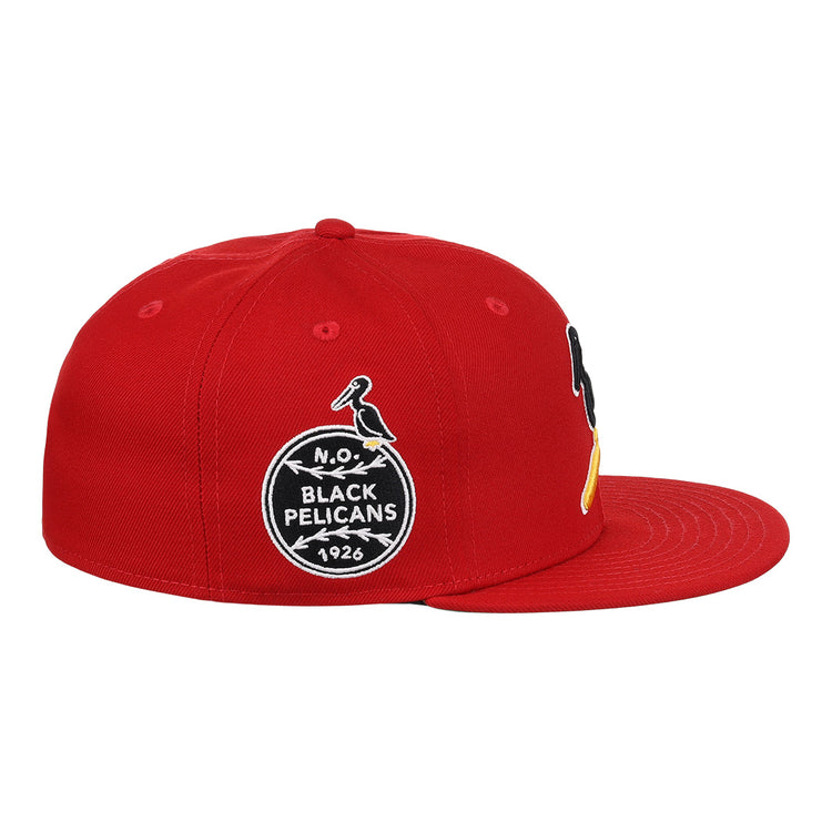 The EFF New Orleans Black Pelicans NLB Team Color Fitted Ballcap in red features embroidered patches, including a circular 1926 Negro Southern League logo with a black-and-yellow pelican on the front.