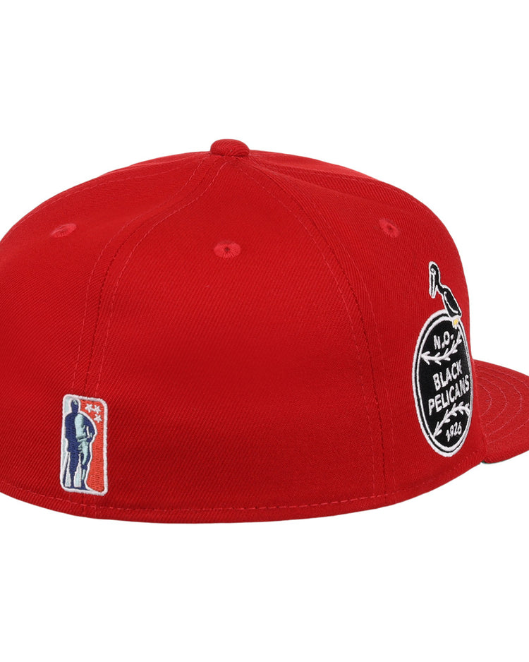 The EFF New Orleans Black Pelicans NLB Team Color Fitted Ballcap in red features a round black-and-white side patch, an embroidered bat-wielding silhouette near the back, flat brim, visible stitching, and Negro Southern League heritage.