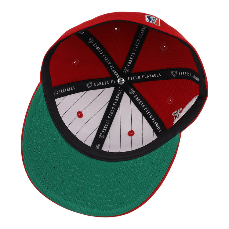 The EFF New Orleans Black Pelicans NLB Team Color Fitted Ballcap in red is shown from underneath, displaying a green brim, white pinstriped lining, black trim with Ebbets Field Flannels text, and an interior MLB logo.