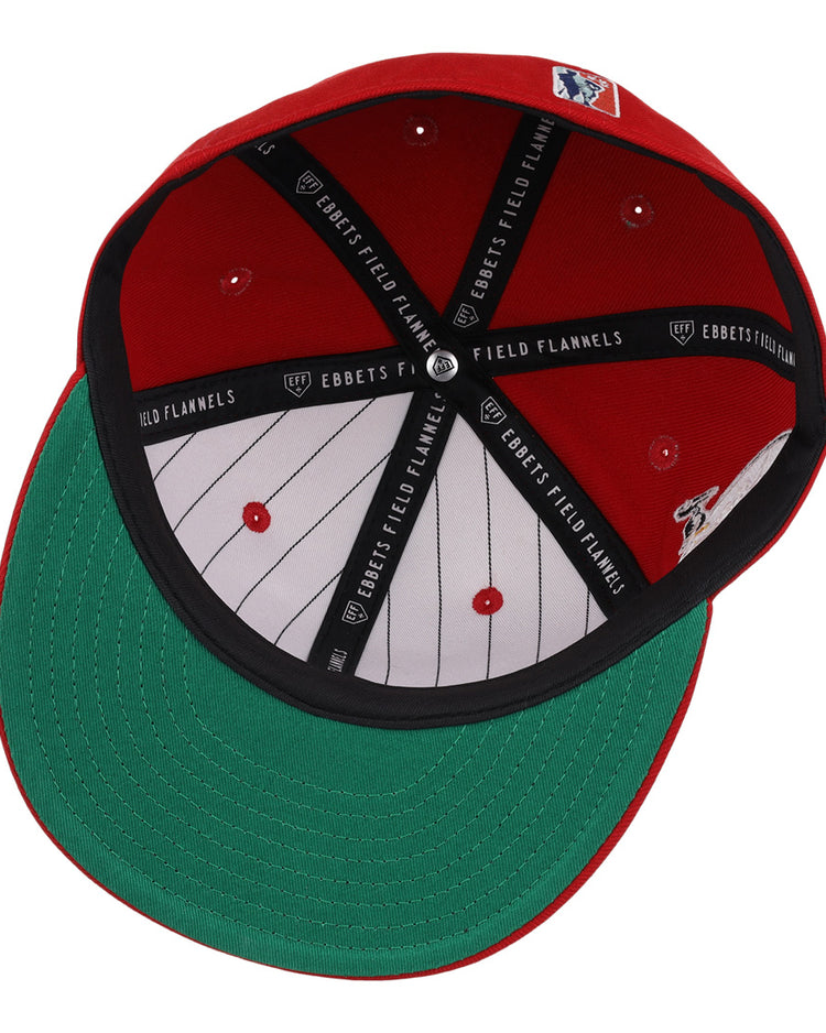 The EFF New Orleans Black Pelicans NLB Team Color Fitted Ballcap in red is shown from underneath, displaying a green brim, white pinstriped lining, black trim with Ebbets Field Flannels text, and an interior MLB logo.