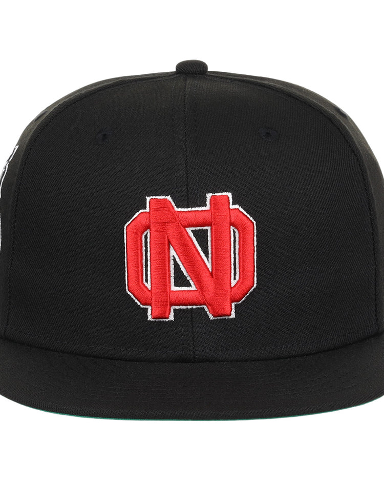 The EFF New Orleans Black Pelicans NLB Team Color Fitted Ballcap in black features a red and white embroidered interlocking N and D logo, inspired by the Negro Southern League’s vintage team style.