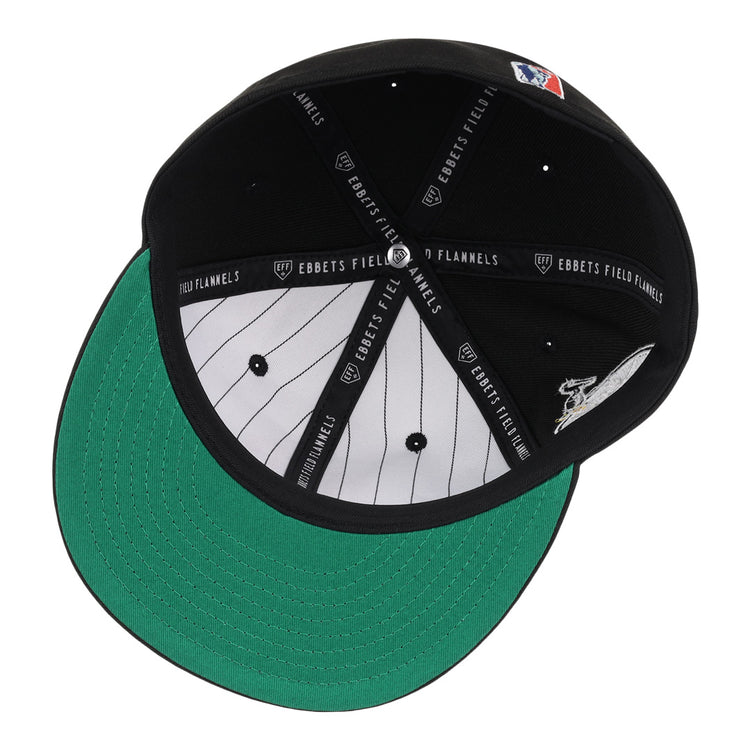 The EFF New Orleans Black Pelicans NLB Team Color Fitted Ballcap in black is shown from below, highlighting its green bill, white pinstriped lining, and EBBETS FIELD FLANNELS text on the black inner seams.