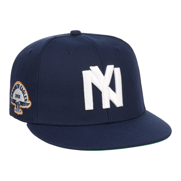 The EFF Brooklyn Eagles NLB Team Color Fitted Ballcap is a navy blue cap with a bold white NY logo on the front and a side eagle patch displaying 1993 and BKLYN EAGLES.