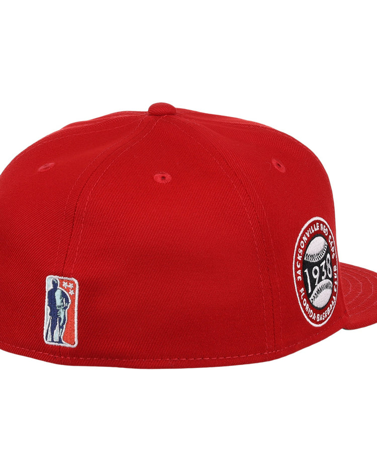 The EFF Jax Red Caps NLB Team Color Fitted Ballcap features a red design, circular 1938 patch with baseball graphic on the right, plus embroidered figure and 3D Negro American League logo on the back.