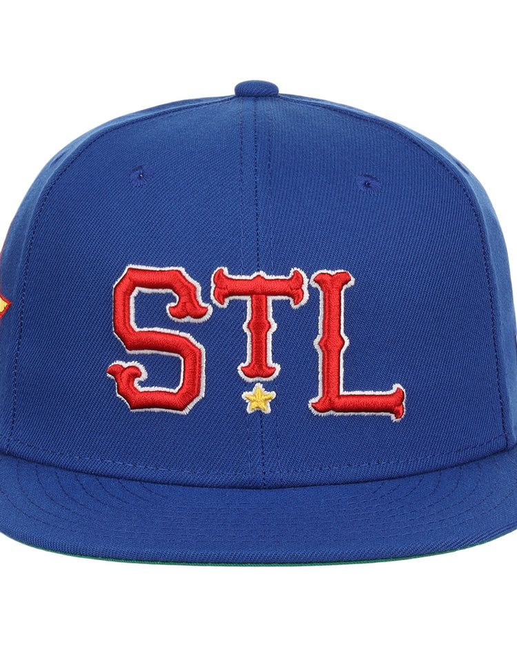 The St. Louis Stars NLB Team Color Fitted Ballcap by EFF features a royal blue design with STL in red and white letters outlined in yellow on the front, plus a small yellow star below, celebrating classic baseball style.