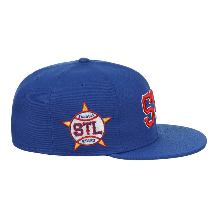 The EFF St. Louis Stars NLB Team Color Fitted Ballcap features a royal blue vintage style, bold red and white STL letters on the front, and a side star patch with STL ST. LOUIS STARS in red and white.