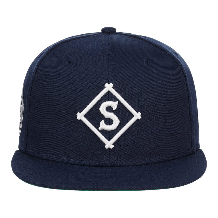 The EFF Seattle Steelheads NLB Team Color Fitted Ballcap features a navy blue design with a flat brim and an embroidered white “S” inside a diamond on the front.