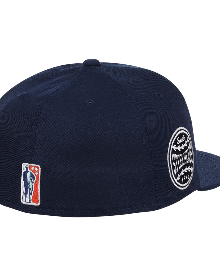 The EFF Seattle Steelheads NLB Team Color Fitted Ballcap is a navy cap with a side circular team patch, embroidered logo with stars near the back, and vintage baseball-inspired detailing.