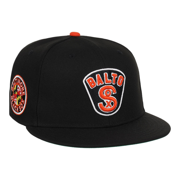 The EFF Baltimore Black Sox NLB Team Color Fitted Ballcap features an embroidered BALTO SOX front logo, a circular Baltimore Black Sox/Eastern Colored League side patch, and orange button and accents for a vintage look.