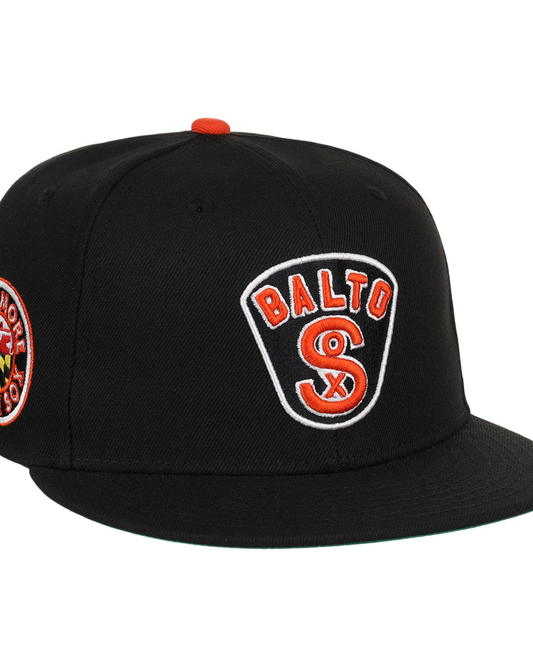 The EFF Baltimore Black Sox NLB Team Color Fitted Ballcap features an embroidered BALTO SOX front logo, a circular Baltimore Black Sox/Eastern Colored League side patch, and orange button and accents for a vintage look.