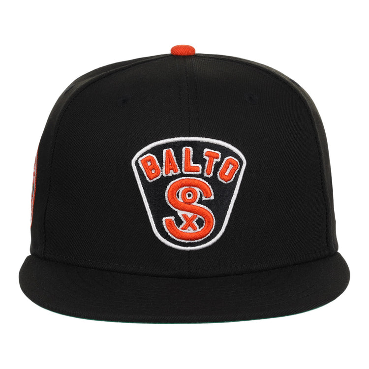 The EFF Baltimore Black Sox NLB Team Color Fitted Ballcap is a vintage-inspired black cap with a flat brim and a front patch reading BALTO above an orange and white S, honoring the Eastern Colored League.