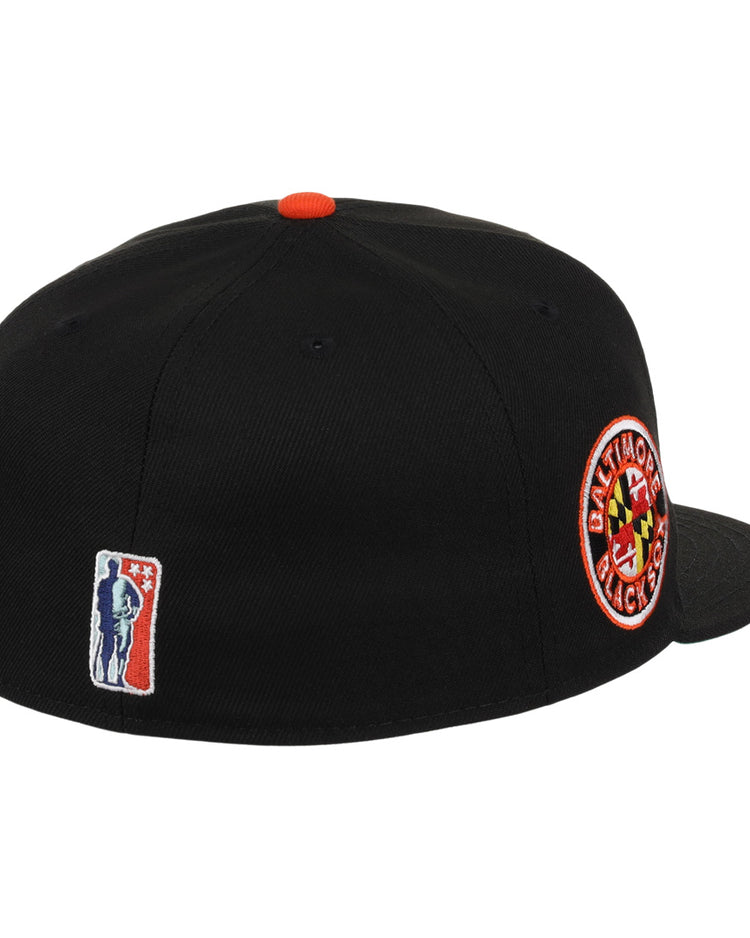 The EFF Baltimore Black Sox NLB Team Color Fitted Ballcap features a vintage look with a circular team patch on the side, red top button, and an embroidered baseball player logo on the back—celebrating Eastern Colored League history.