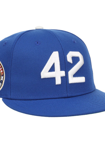 The EFF Jackie Robinson Signature Series Royal Fitted Ballcap features a white 42 on the front and a side patch with Jackie Robinson’s image and number—honoring his enduring legacy.